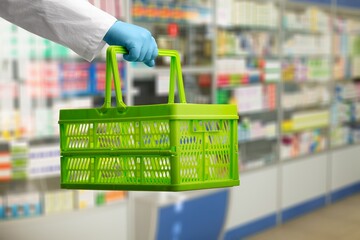 A medic's hand holds a grocery basket whether a package