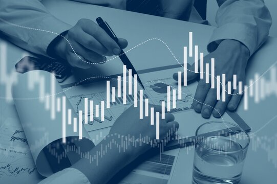 Business meeting with documents and graphs on desk - Powered by Adobe