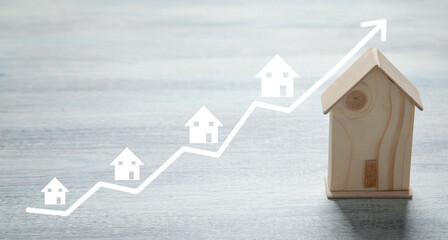 Real Estate Investment. House model with a growth graph
