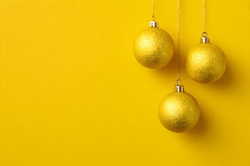 Yellow Christmas Baubles and Decoration on yellow Background with Copy Space for Holiday Celebration