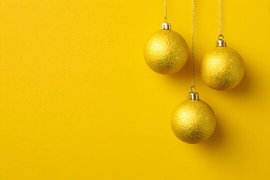 Yellow Christmas Baubles and Decoration on yellow Background with Copy Space for Holiday Celebration