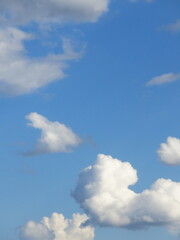 blue sky with bright white fluffy clouds