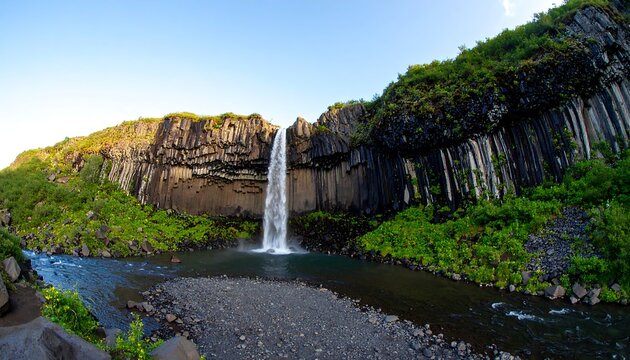 Majestic waterfall over dramatic basalt columns