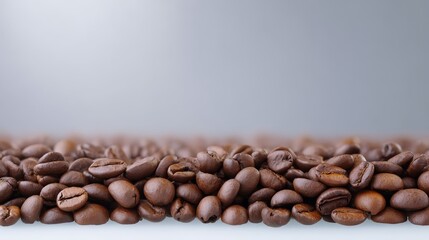 Obraz premium Coffee beans scattered across clean white surface brown coffee beans displayed on pristine white background