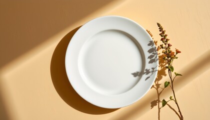 A white plate with a simple geometric design, set against a backdrop that appears to be an interior setting with warm lighting