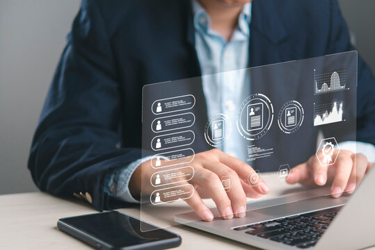 Businessman analyzing employee performance on HR management software dashboard. Reviewing digital CVs, personnel data for corporate development. Technology for modern recruitment strategy.