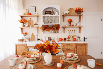 Beautiful autumn table setting with seasonal decor in a cozy kitchen