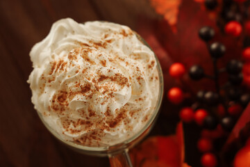Warm whipped cream delight with cinnamon on top in autumn setting