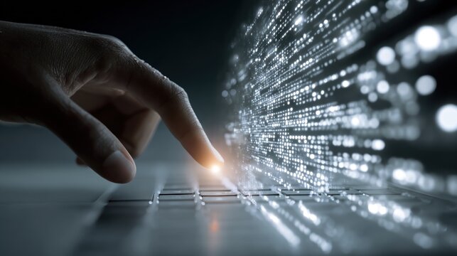Hand touches glowing data stream on computer keyboard digital technology