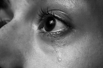 Closeup view of sad woman crying. Black and white effect