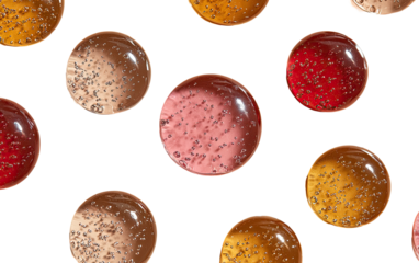 Round, colorful, translucent treats on black