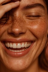 Woman with natural freckles smiling broadly, showing joy, happiness, and authentic beauty with healthy skin