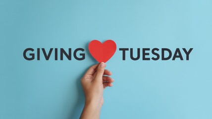 Giving tuesday concept with heart in hand on blue background, donation and care