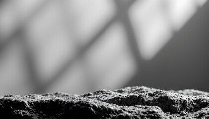 A close up view of a textured surface that resembles concrete or stone, with light and shadows playing across it