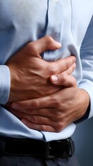 Man Wearing Blue Shirt Suffering From Stomach Pain or Discomfort