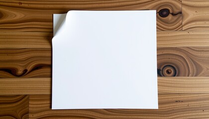 Naklejka premium A blank white card is placed centrally on a wooden surface.