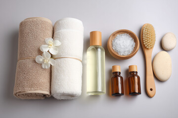 A set of isolated cosmetic products including a spa bottle, towel, and cream for body care and beauty treatment
