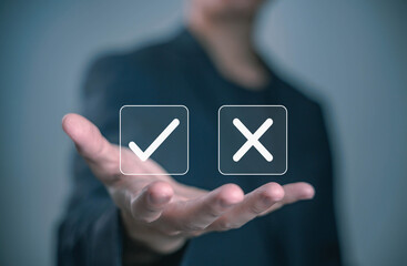 Businessman holding check mark and cross icons, representing decision making, approval, rejection, evaluation, and business management concept. yes or no concept