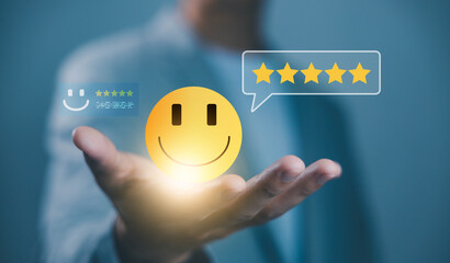 Businessman holding a smiling face and five-star rating icons, representing customer satisfaction, positive feedback, service review, and excellent customer experience concept.