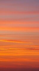 Fototapeta premium Striking Sunset Sky with Vibrant Orange Yellow and Purple Clouds in Atmospheric Landscape