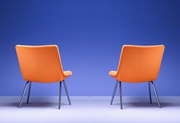 Two chairs positioned with backs touching, facing opposite directions, modern, pair