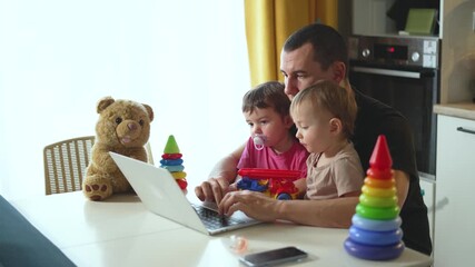 Father children at home at table with laptop toys. shared time between father children. Family time. children play with toys. Father child bond over shared table balancing work play. happy childhood. - Powered by Adobe