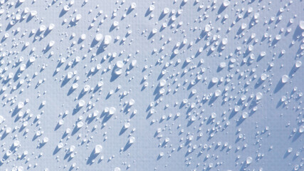 A close up of a wet surface with many small droplets of water