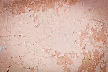 A wall with a lot of cracks and holes