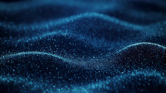 Abstract blue macro shot of small particles forming undulating, bokeh-filled waves