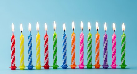 Colorful Birthday Candles Lit Together Against a Blue Background