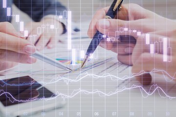 Business meeting with documents and graphs on desk