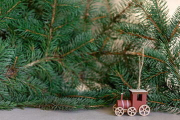 Wooden Christmas train with pine branch background