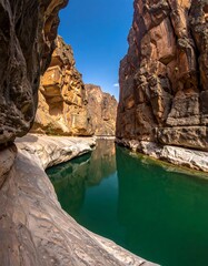 Green river surrounded by rocky canyon walls