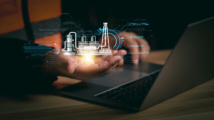 Engineer using laptop with holographic smart factory system showing industrial technology, automation, and innovation in manufacturing process for digital industry and future engineering concept.