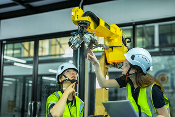 In an Industry 4.0 smart factory, an engineer uses a tablet to run an AI machine vision algorithm on a collaborative robot cobot, optimizing production via a real time digital twin.