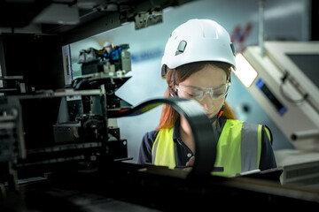 In an Industry 4.0 smart factory, an engineer uses a tablet to run an AI machine vision algorithm on a collaborative robot cobot, optimizing production via a real time digital twin.