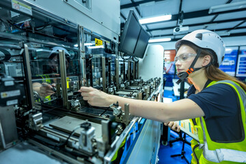 In an Industry 4.0 smart factory, an engineer uses a tablet to run an AI machine vision algorithm on a collaborative robot cobot, optimizing production via a real time digital twin.