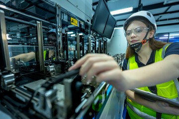 In an Industry 4.0 smart factory, an engineer uses a tablet to run an AI machine vision algorithm on a collaborative robot cobot, optimizing production via a real time digital twin.