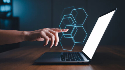 Modern digital interface with hexagons and hand interacting with laptop screen