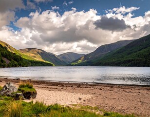 Lake view surrounded by mountains under a cloudy sky
