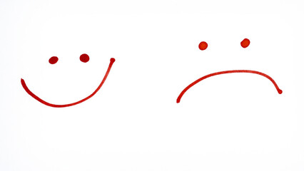 Simple hand-drawn red smiley and sad face symbols on a transparent background.
