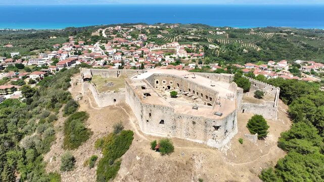 Aerial drone cinematic video of Frankish Castle of Chlemoutsi in area of Kylini overlooking small village of Kastro and deep blue sea, Peloponese, Ilia, Greece