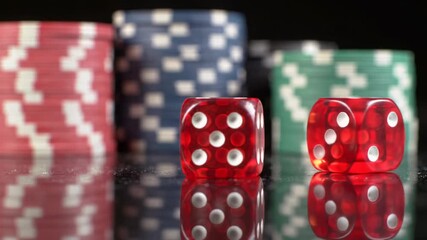 A slow-motion close-up of translucent red dice with white pips rolling on a reflective dark surface, dramatic low-key lighting, blurred poker chips, concept of high stakes and refined luxury. - Powered by Adobe