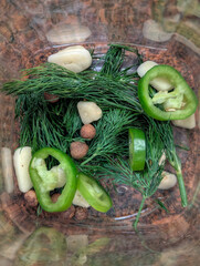 Pickling Ingredients Inside a Glass Jar with Dill, Garlic, Green Pepper, and Allspice