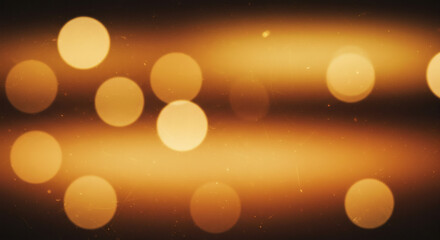 Warm glowing abstract background with golden bokeh lights creating a festive and magical atmosphere