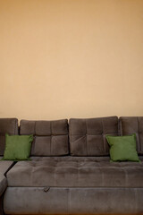 A soft corner sofa with carriage coupler and a clean, solid wall for copyright