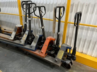 Hand pallet trucks for moving goods in a warehouse