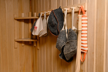 The interior of a classic steam room finished in light wood with a corner bench.