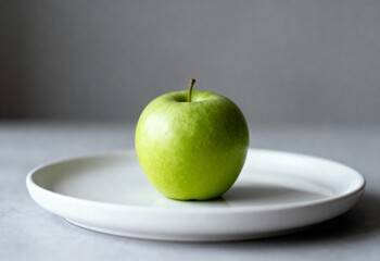 Minimalist closeup of single green apple on white plate