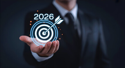 2026 Business Success Concept – Businessman Holding Goal Icon as a Symbol of Achievement, Development, and Strategic Planning. Corporate Vision and Motivation for Growth in the New Year